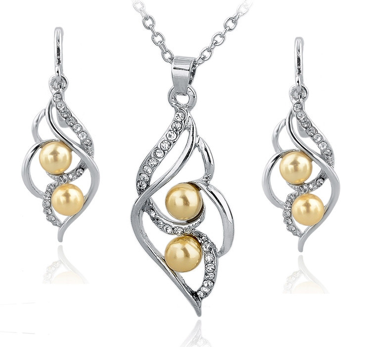 Smyckeset med Austrian Crystals och Simulated Pearls - 925 Sterling Silverplätering och gula Pärlor